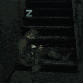 a man sitting on a set of stairs with the letter n on the bottom steps