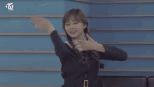 two girls in school uniforms are making a heart shape