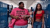 a man in a pink shirt with barbz pon di station heal on it