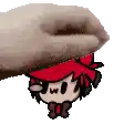 a hand is holding a cartoon character with a red hat and bow tie .