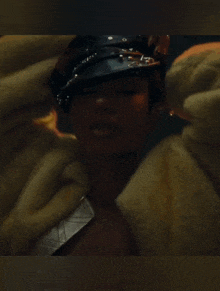 a close up of a woman wearing a fur coat
