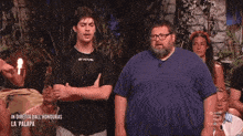a man in a givova shirt stands next to a man in a blue shirt