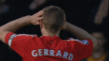 a man in a red jersey with the name gerrard on it