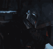 a close up of a person 's helmet with a red light coming out of it