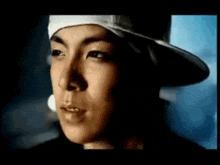 a close up of a man wearing a hat and bandana