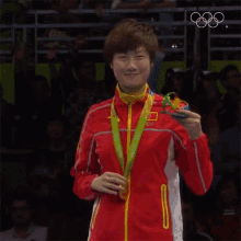 showing her medal ding ning olympics exhibiting the medal winner