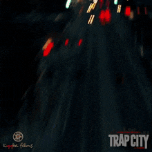a man wearing glasses is talking on a phone with trap city written on the bottom right