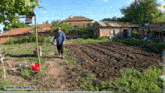 a man standing in a field with the website milchevi.bg visible