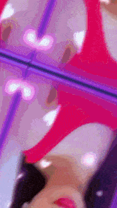 a woman 's face is reflected in a mirror while wearing a red top