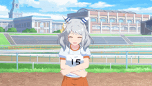 a girl with the number 15 on her shirt stands with her arms crossed