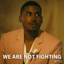 a man in a pink suit says we are not fighting on a netflix poster
