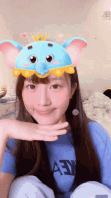 a girl wearing a blue shirt that says aey