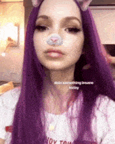 a girl with purple hair has a cat filter on her face and the caption says doin something insane today