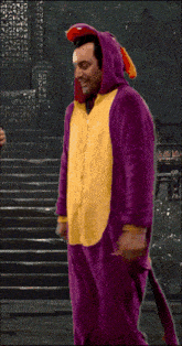 a man in a purple and yellow animal costume is dancing