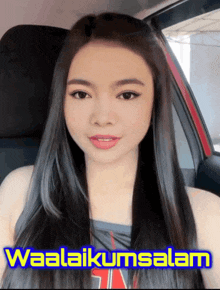 a woman sitting in a car with the words waalaikumsalam on the bottom