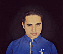 a man wearing a blue shirt with the letter f on the front