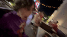 a blurry picture of a person eating a sandwich
