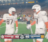 two texas a & m football players are standing on the field