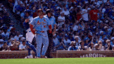 a baseball player wearing a blue jersey with the number 63 on it