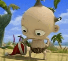 a cartoon baby is holding a santa hat on a sandy beach .