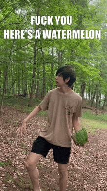 a young man holding a watermelon with the words fuck you here 's a watermelon on the bottom