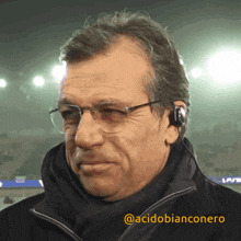 a man wearing glasses and headphones has the username @acidobianconero on the bottom