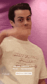 a young man wearing a t-shirt that says " not from paris "
