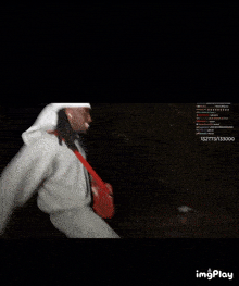 a man with dreadlocks is walking in the dark with a red bag on his shoulder and a watermark that says imgplay