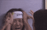 a woman with a bandage on her head is being held by two other women