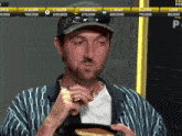 a man eating a pancake in front of a screen that says mongeau 275,000