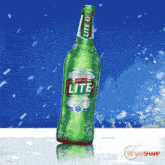 a green bottle of castle lite beer is sitting on a table