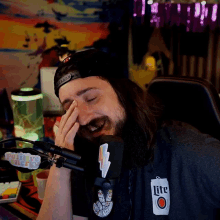 a man wearing a miller lite shirt is laughing