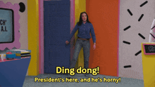 a woman standing in front of a door that says ding dong