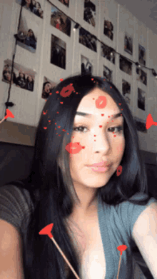 a woman taking a selfie with hearts and arrows on her face