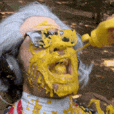 a man wearing sunglasses and headphones is covered in yellow liquid