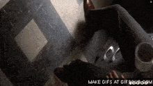 a gif of a person laying on the floor with the words make gifs at gifsoup.com below it