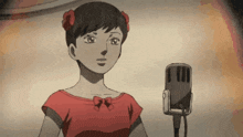 a woman in a red dress is standing in front of a microphone