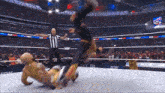 a wrestler is being thrown in the air by a referee in a wrestling ring that says all in