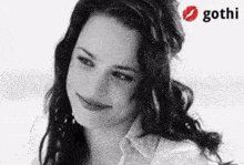 a black and white photo of a woman with a gothi logo