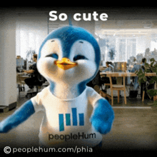 a stuffed penguin wearing a peoplehum t-shirt