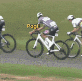 a group of cyclists are riding down a road and one of them is shouting pogi