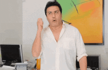 a man in a white shirt is standing in front of a dell computer monitor