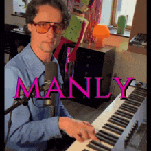 a man in a blue shirt is playing a keyboard with the word manly in pink