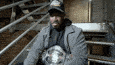 a man sitting on a set of stairs holding a belt that says world heavyweight champion