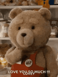 a teddy bear wearing a red apron is standing in front of a refrigerator and says `` love you so much ! ''