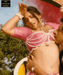 a woman in a pink top is being touched by a man with the words hot actresses hotties on the bottom