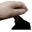 a close up of a person 's hand holding a black object on a white background .