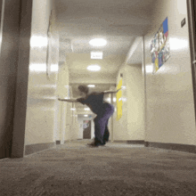 a person is standing in a hallway with a sign that says exit