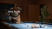 a teddy bear is holding a pool cue and playing pool