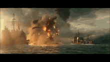 a large explosion in the middle of the ocean with ships in the water .